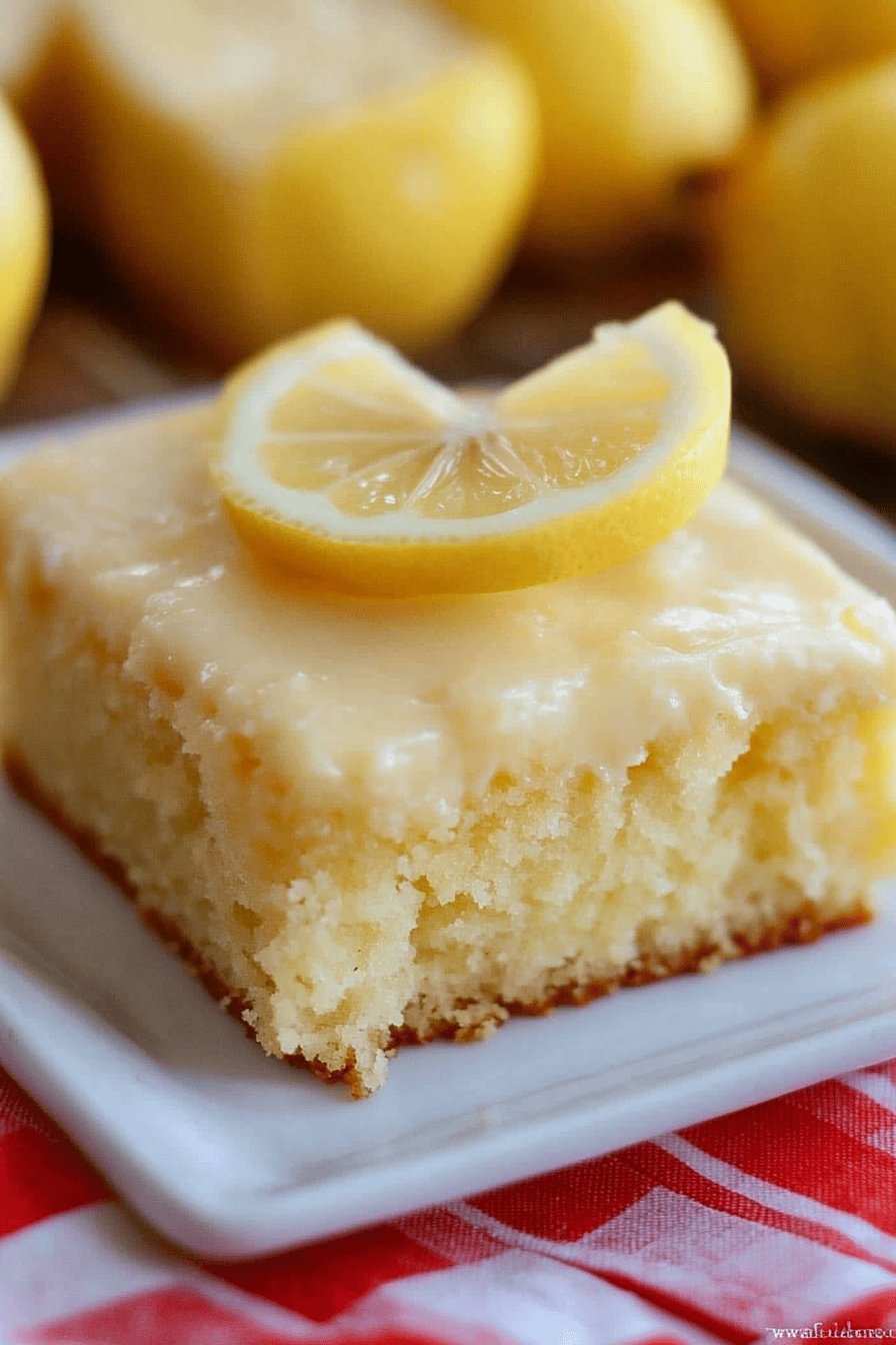 Lemon Sheet Cake slice on plate showing perfect texture and swirl pattern