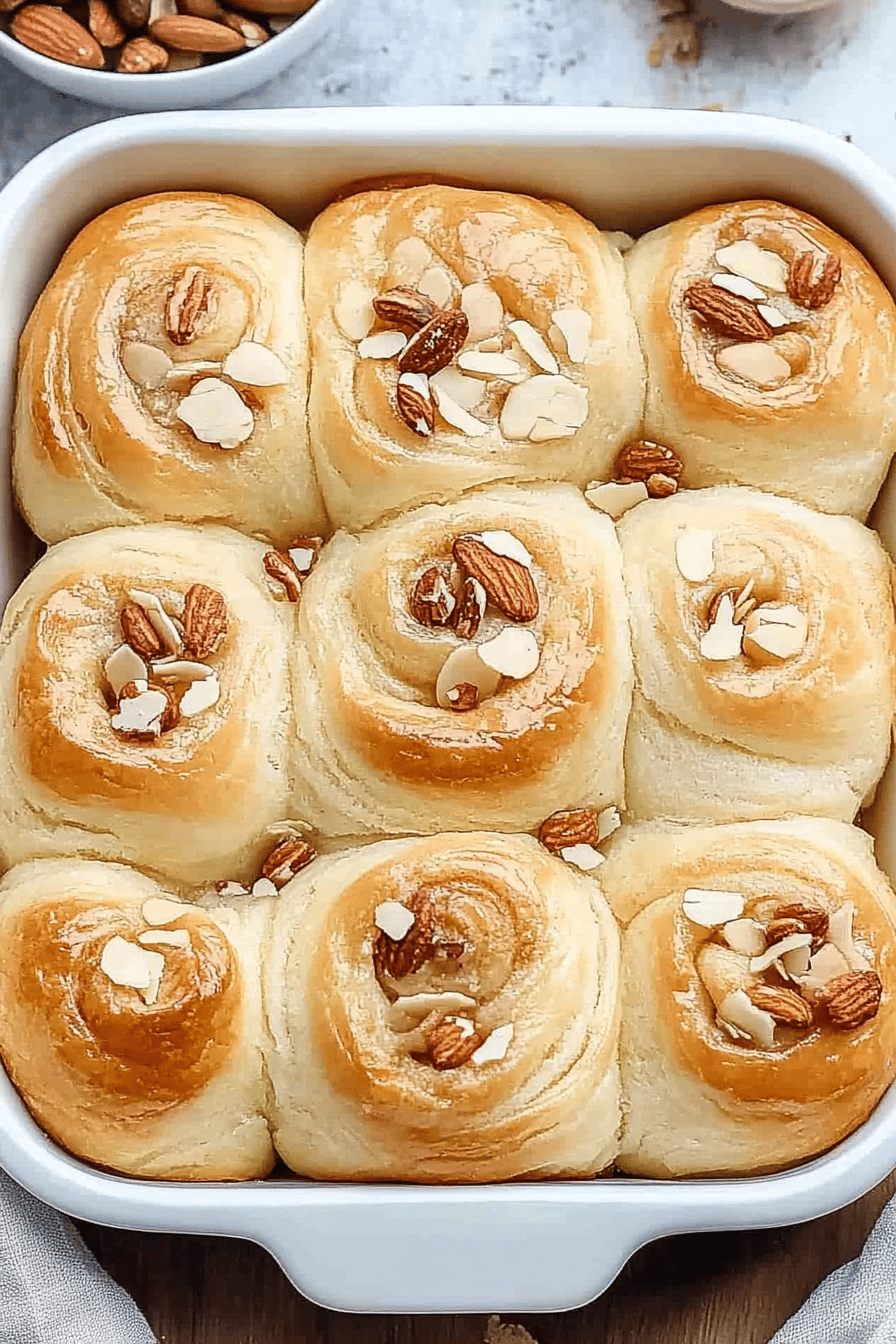 almond croissant cinnamon rolls slice on plate showing perfect texture and swirl pattern