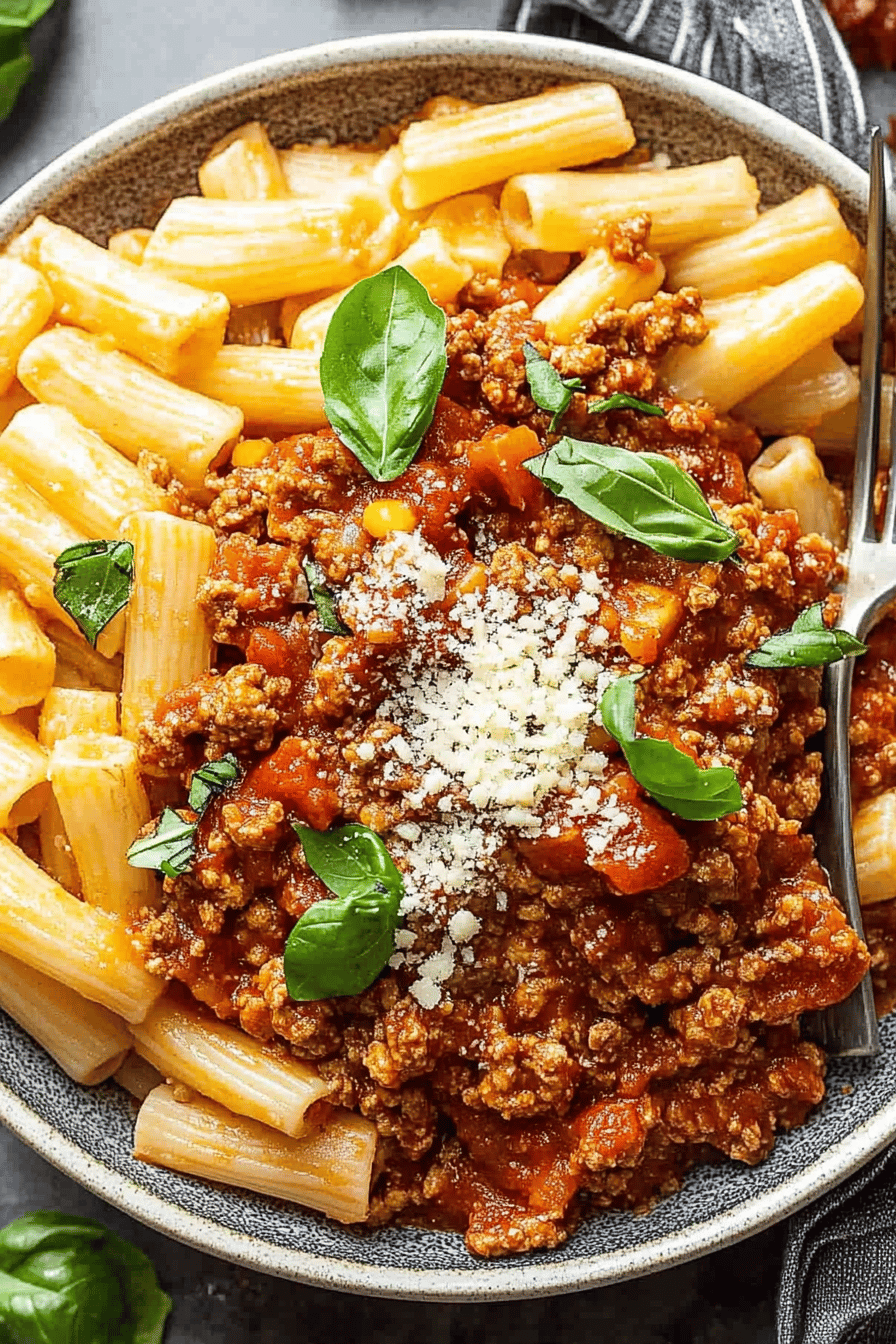 ground chicken bolognese slice on plate showing perfect texture and swirl pattern