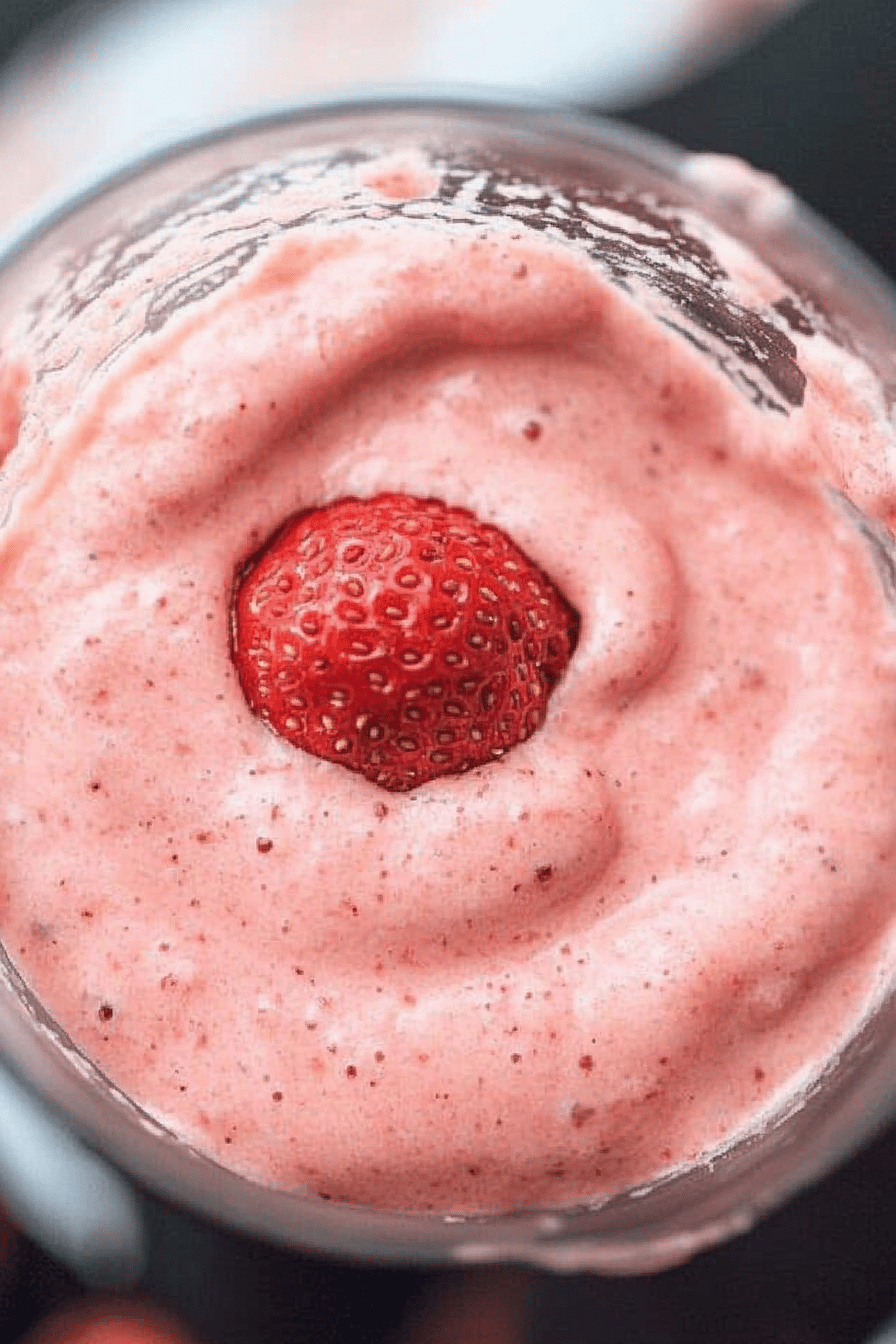 strawberry smoothie ingredients organized and measured on kitchen counter