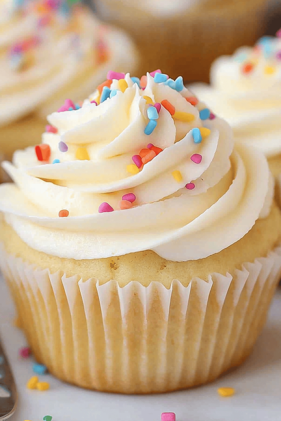 vanilla cupcakes slice on plate showing perfect texture and swirl pattern